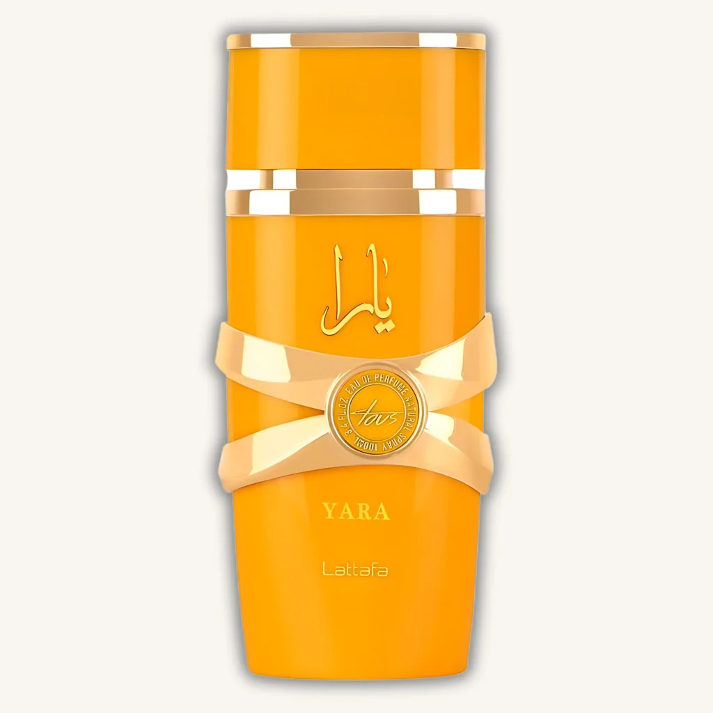 Botella del perfume Lattafa Yara Tous con diseño cilíndrico color naranja y detalles dorados, fragancia femenina tropical y dulce.